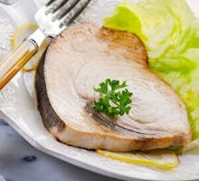 cooked swordfish steak with greens
