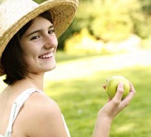 Teen girl eating an apple